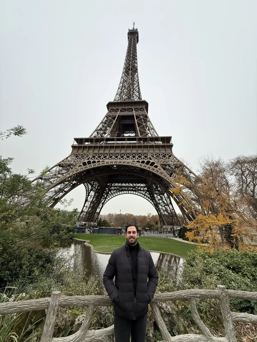 Augusto em frente à Torre Eiffel, em Paris